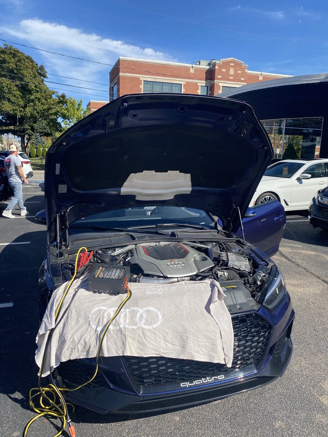 Audi RS5 with hood open during mobile programming service